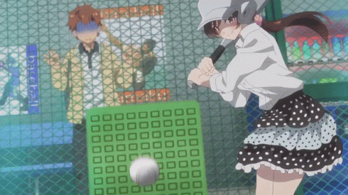 A Girl Is Swinging A Bat At A Baseball Behind A Fence GIF
