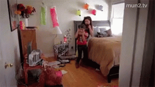A Girl Is Taking A Picture Of Herself In A Messy Bedroom GIF