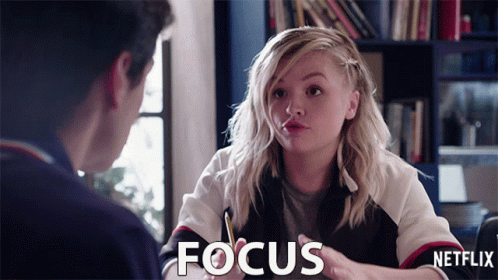 A Girl Is Talking To A Man And The Word Focus Is On The Screen GIF
