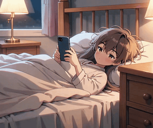 A Girl Laying On A Bed Looking At Her Phone GIF