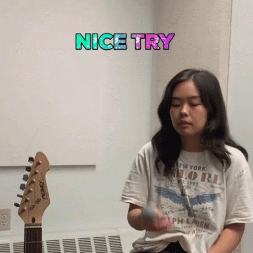 A Girl Playing A Guitar With A Nice Try Sticker Above Her GIF