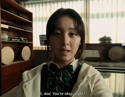A Girl Says Hi Dad You 'Re Okay Right In Front Of A Window GIF