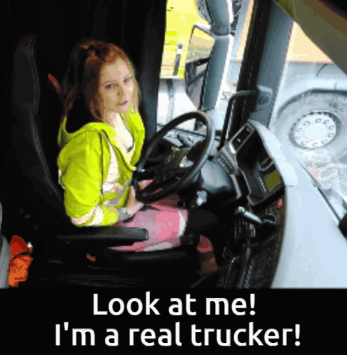 A Girl Sitting In A Truck With The Words Look At Me I 'M A Real Trucker Below Her GIF