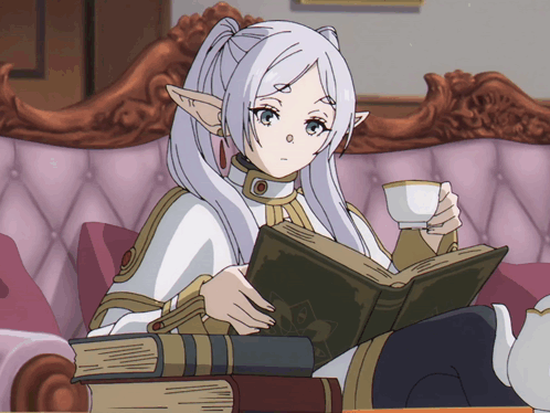 A Girl Sitting On A Couch Reading A Book And Drinking From A Cup GIF