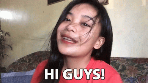 A Girl Sitting On A Couch With The Words Hi Guys Written On Her Face GIF