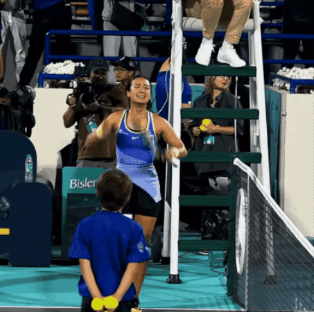 A Girl Stands In Front Of A Sign That Says Bisler On It GIF