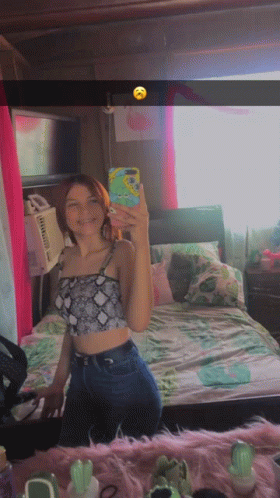 A Girl Taking A Selfie In Front Of A Mirror GIF