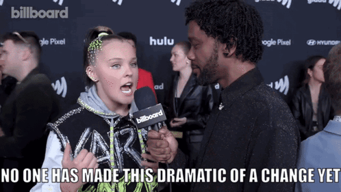 A Girl Talking Into A Billboard Microphone GIF