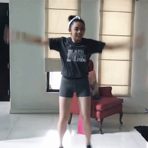 A Girl Wearing A Black Shirt That Says " Black Magic " GIF