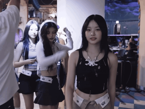 A Girl Wearing A Black Tank Top With A White Bunny On It GIF