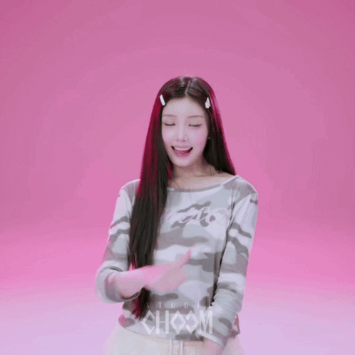 A Girl Wearing A Camouflage Shirt With The Word Studio On The Front GIF