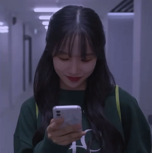 A Girl Wearing A Green Sweatshirt With The Letter N On It GIF