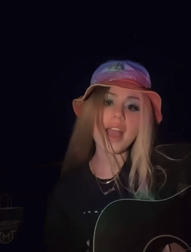 A Girl Wearing A Hat That Says Cowboys On It GIF