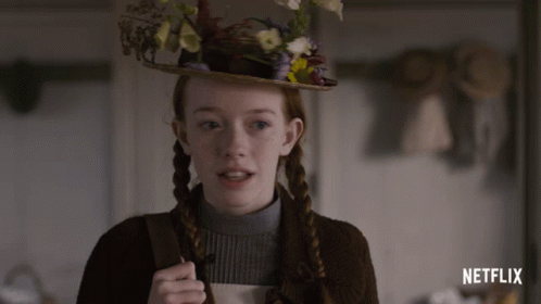 A Girl Wearing A Hat With Flowers On It And The Word Netflix On The Bottom GIF