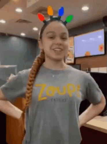 A Girl Wearing A Headband With Lights On It And A T-Shirt That Says Zoup GIF