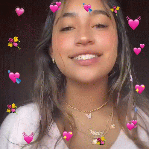 a girl wearing a necklace that says " angel "