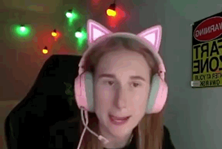 a girl wearing a pair of pink cat ears headphones with a microphone .