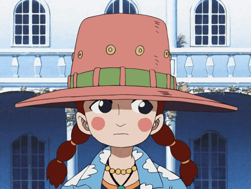 A Girl Wearing A Pink Hat With Circles On It Stands In Front Of A Building GIF