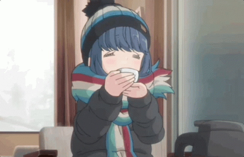 A Girl Wearing A Scarf And A Hat Is Holding A Cup GIF