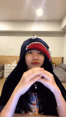 A Girl Wearing A Shark Hoodie And A Dye Shirt GIF