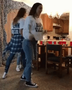A Girl Wearing A Shirt That Says Happy Vals Is Dancing In A Kitchen GIF