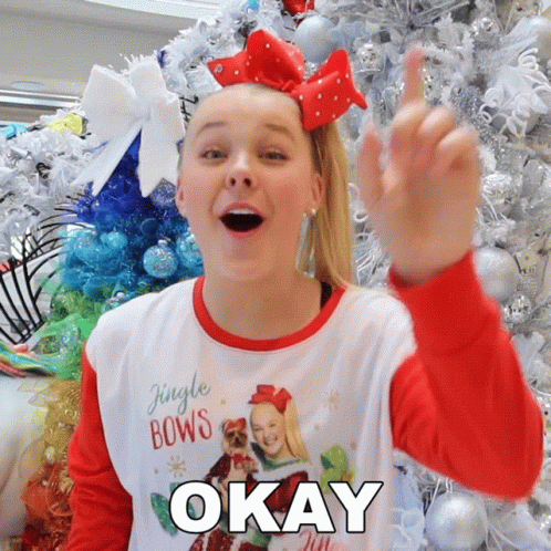 A Girl Wearing A Shirt That Says Jingle Bows Is Giving The Middle Finger GIF