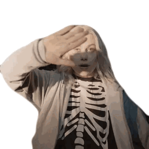 a girl wearing a skeleton shirt covering her face with her hand