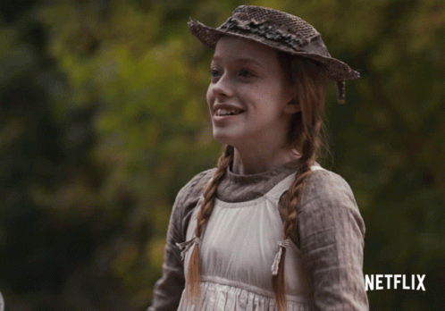 A Girl Wearing A Straw Hat And A White Dress With A Netflix Logo In The Corner GIF