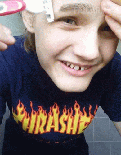 A Girl Wearing A Thrasher Shirt Shaves Her Eyebrows With A Razor GIF