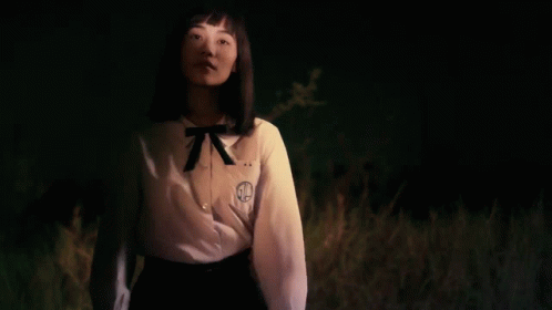 A Girl Wearing A White Shirt With The Letter G On The Front GIF