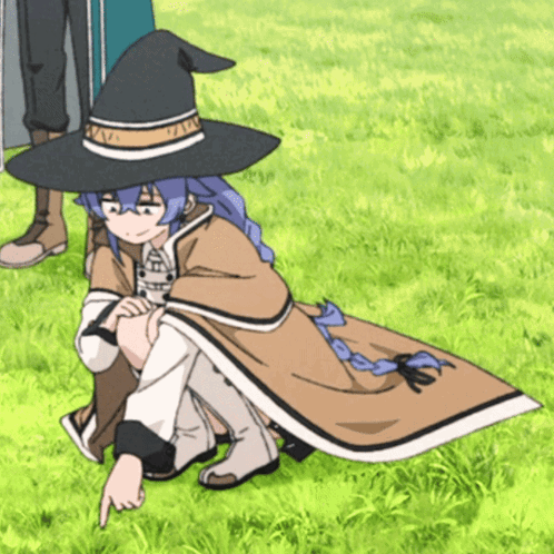 A Girl Wearing A Witch Hat Is Pointing At Something In The Grass GIF