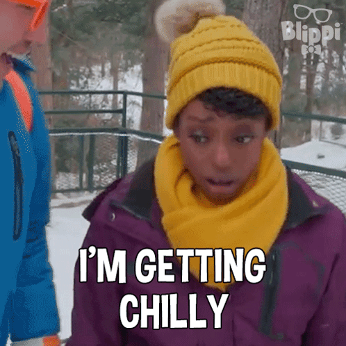 A Girl Wearing A Yellow Hat And Scarf Is Saying I 'M Getting Chilly GIF