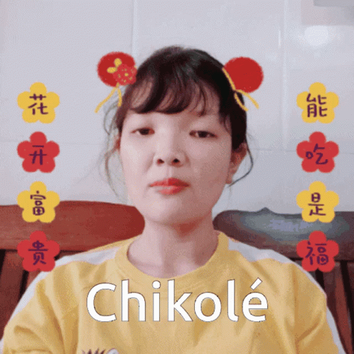 A Girl Wearing A Yellow Shirt With Chikole Written On It GIF