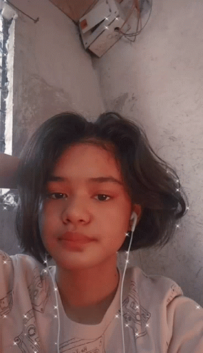 A Girl Wearing Ear Buds And A Shirt That Says ' I Love You ' On It GIF