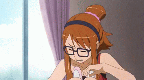 A Girl Wearing Glasses And A Headband Is Looking Down GIF