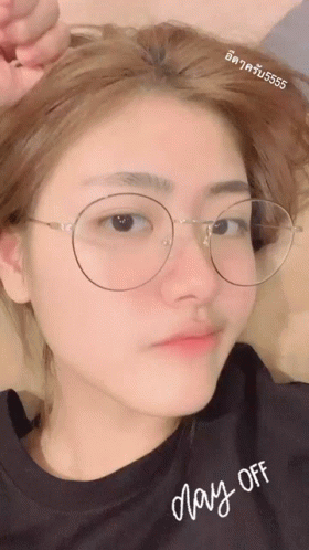 A Girl Wearing Glasses And A Shirt That Says May-Off GIF