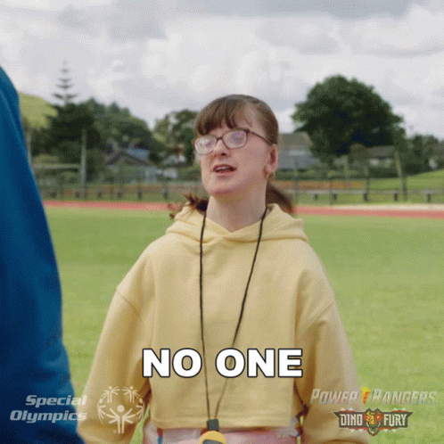 A Girl Wearing Glasses And A Yellow Sweatshirt Says No One GIF