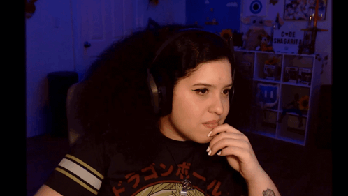 A Girl Wearing Headphones And A Dragon Ball Shirt GIF