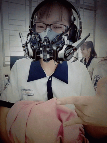 A Girl Wearing Headphones And A Gas Mask Has The Name Thanh Thao On Her Shirt GIF
