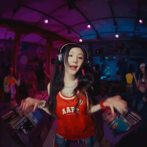 A Girl Wearing Headphones And A Red Shirt That Says Aap On It GIF