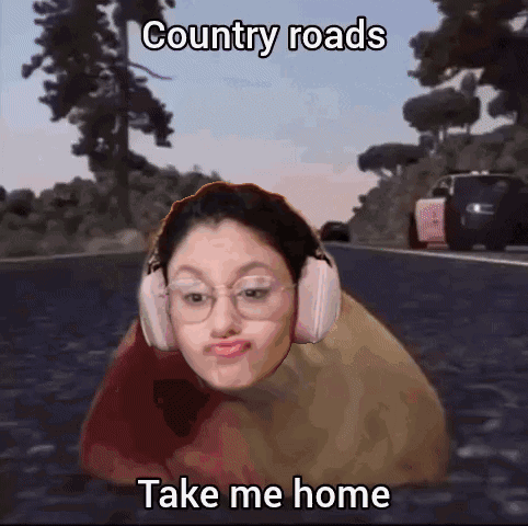 A Girl Wearing Headphones Is Laying On A Road With The Caption Country Roads Take Me Home . GIF