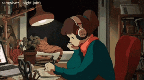 A Girl Wearing Headphones Is Sitting At A Desk With A Laptop GIF
