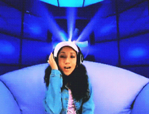 a girl wearing headphones is sitting in a chair