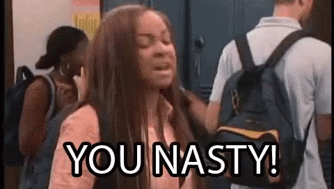 A Girl With A Backpack Is Standing In Front Of A Group Of People . GIF