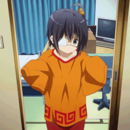 A Girl With A Bandage On Her Eye Is Standing In A Doorway Wearing An Orange Shirt With Chinese Symbols On It GIF