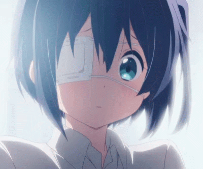 A Girl With A Bandage On Her Eye Looks At The Camera GIF