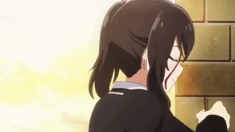 A Girl With A Bloody Face Is Standing Next To A Brick Wall GIF