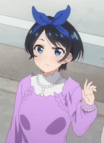 A Girl With A Blue Bow On Her Head Is Wearing A Purple Shirt And Pearls GIF