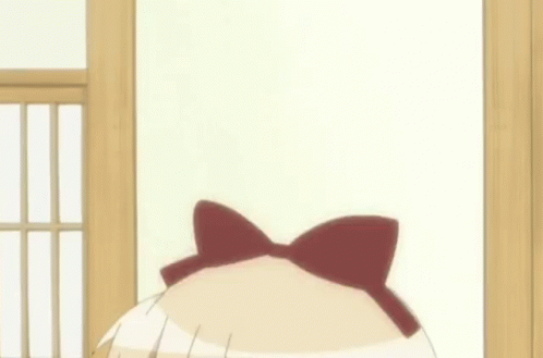 A Girl With A Bow On Her Head Is Making A Funny Face GIF
