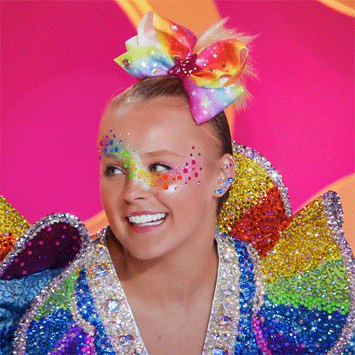 Girl With Colorful Bow Smiling GIF